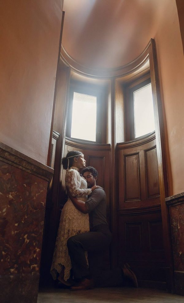 Woman standing with man kneeling in front of her. Woman lives with mental health issues.